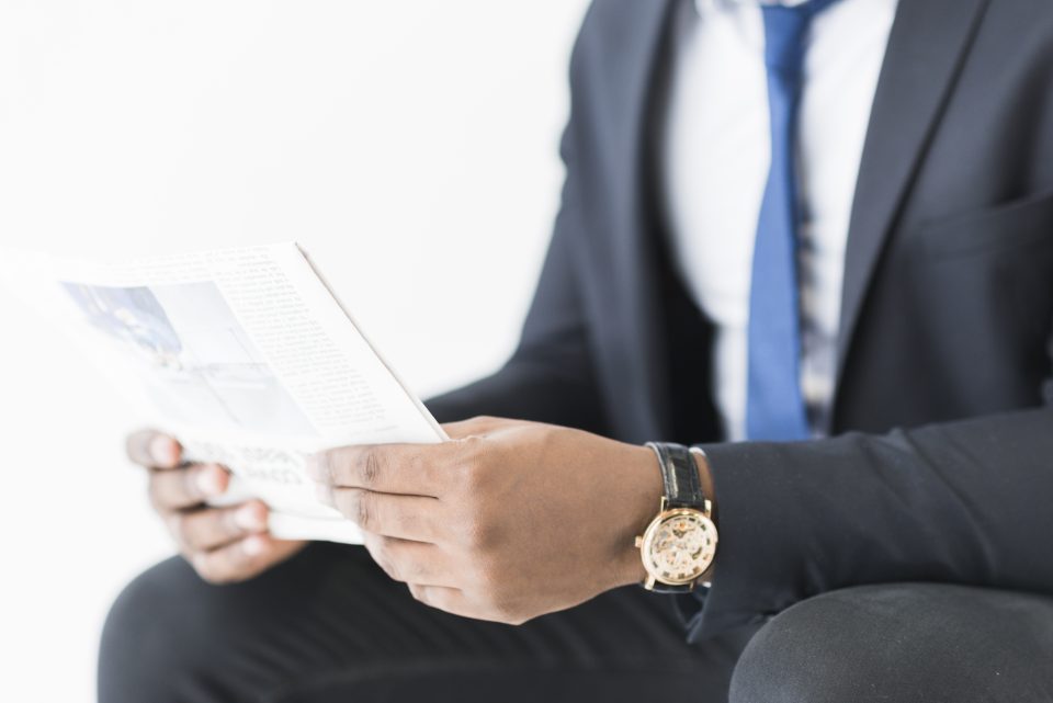 Investor reading current financial news and research