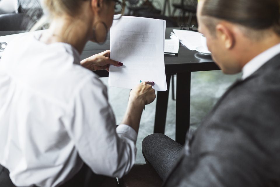 Adviser and client reviewing account-opening documents